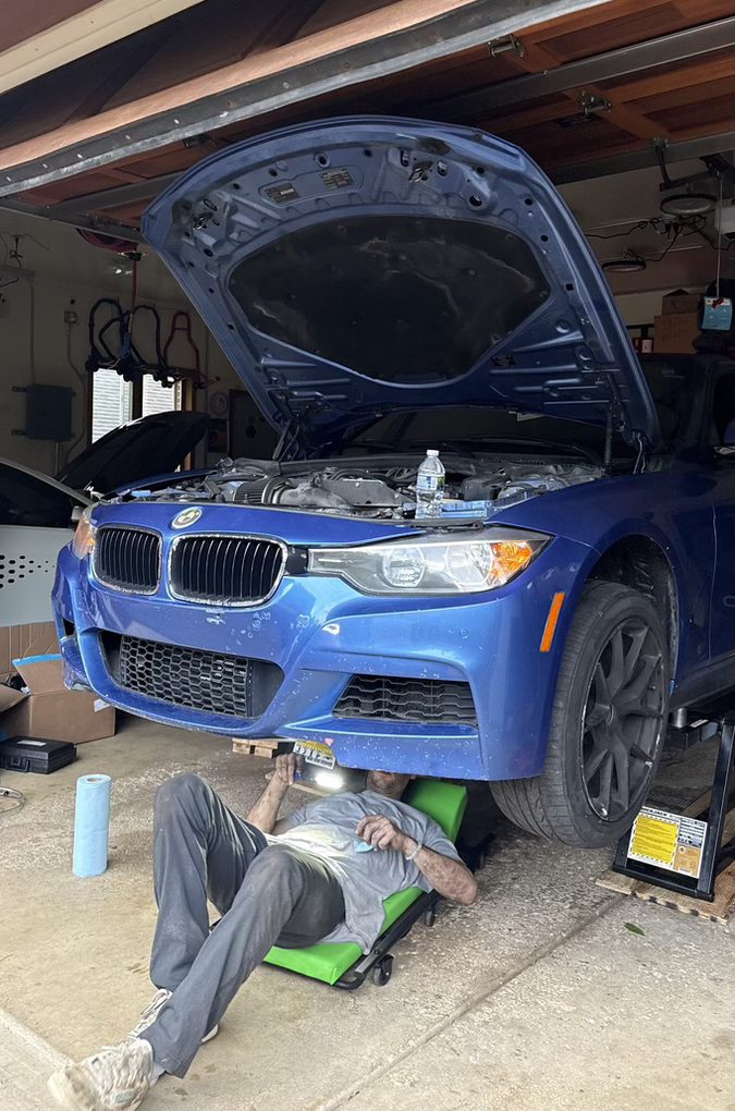 Technician working under a car